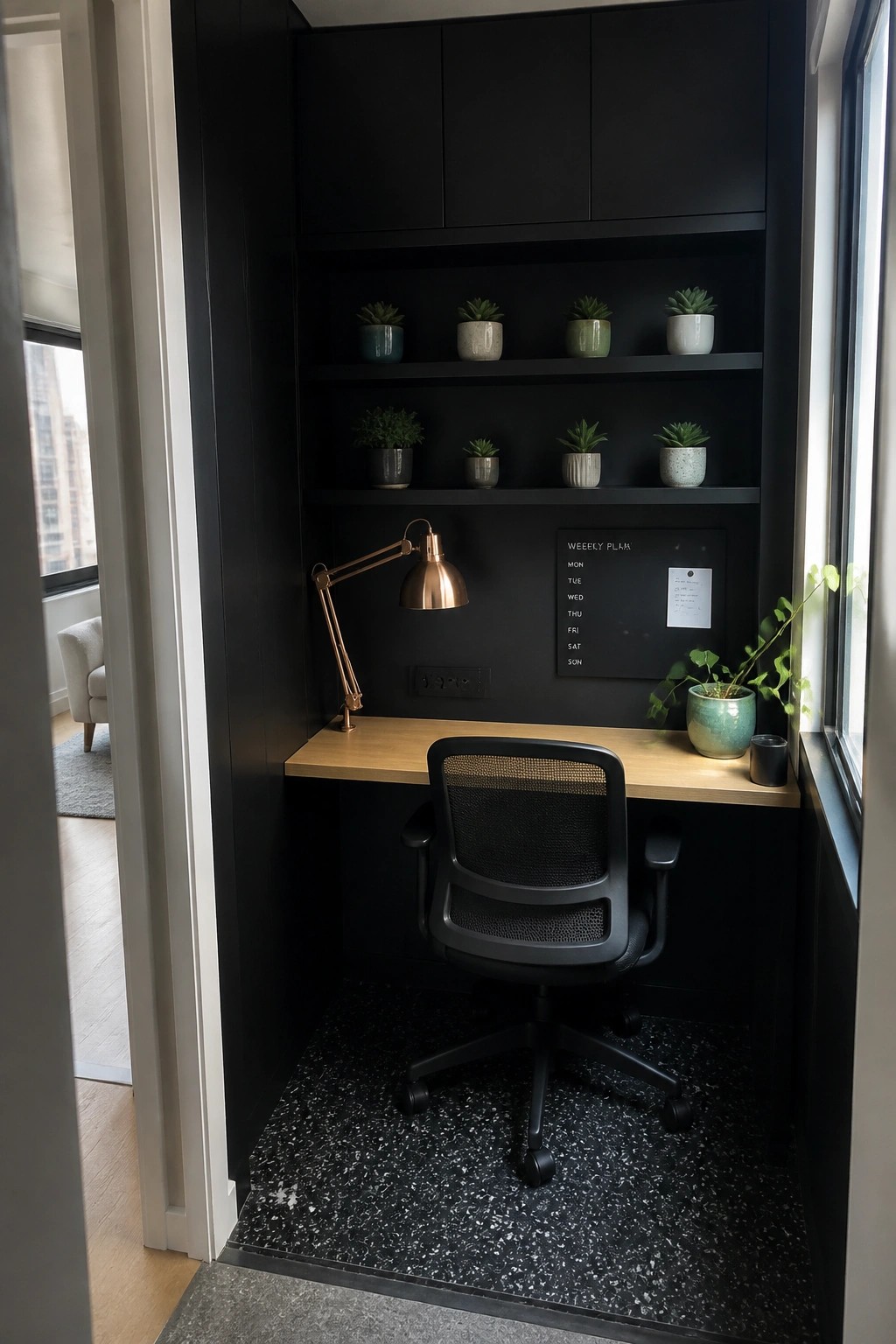 Modern black office nook with wooden desk, mesh chair, copper lamp, and plant shelves.