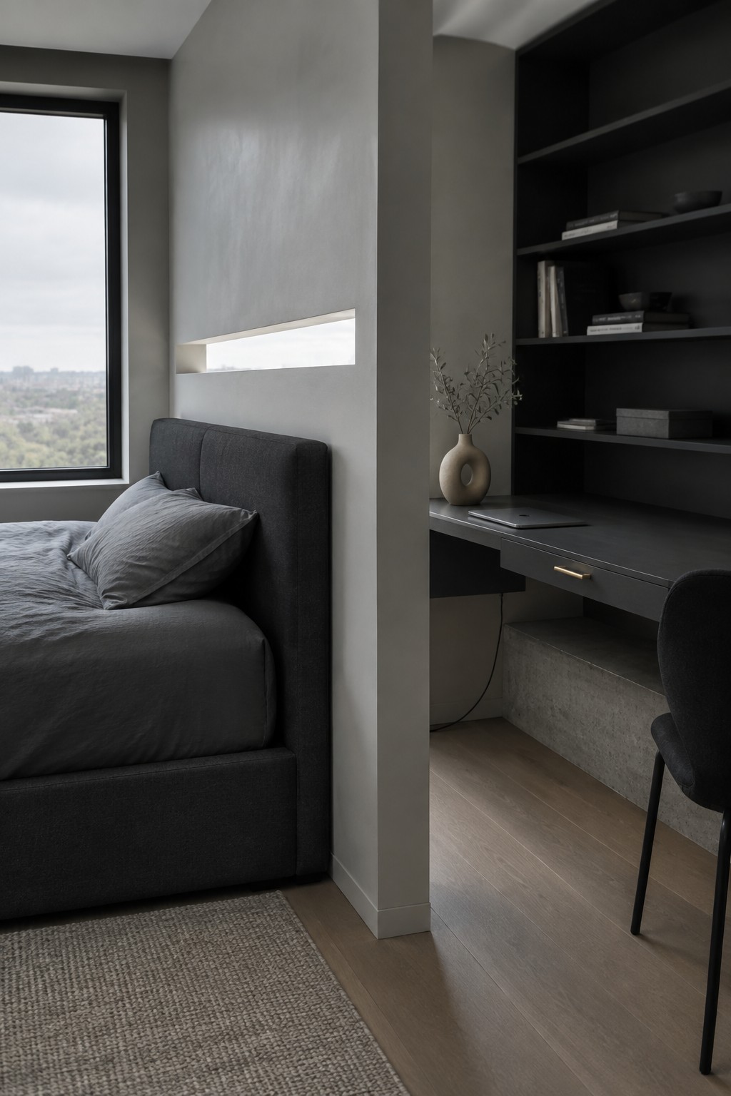 Modern dark gray bedroom with upholstered bed, built-in desk, shelves, and city view window